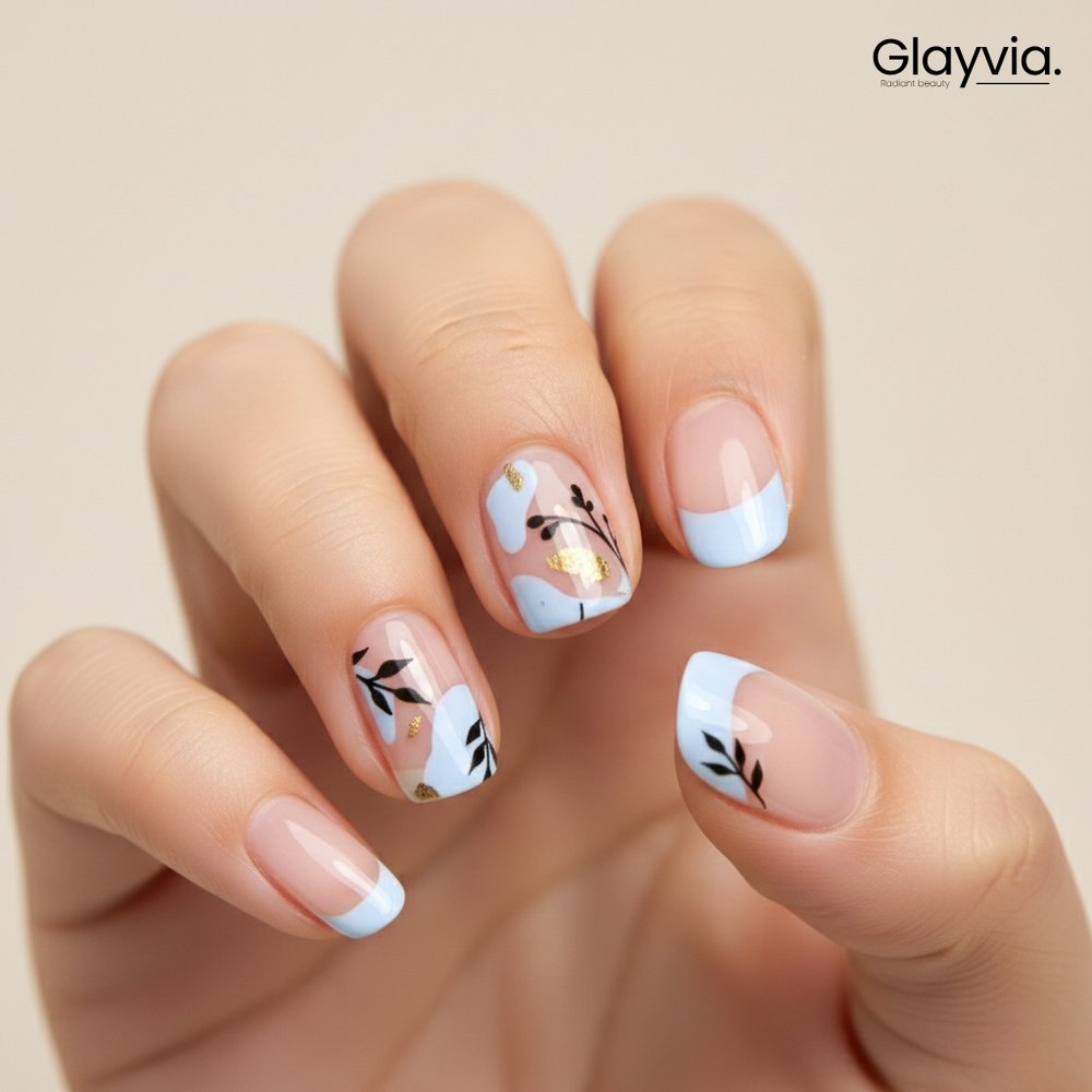 Macro closeup of Glayvia NG200019 blue petal French semi cured gel nail wraps with soft blue French tips black leaf design and gold accents