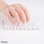 Hand wearing Glayvia NG200045 soft white french shimmer semi cured gel nail wraps displayed above matching white french tip nail wrap sticker sheet