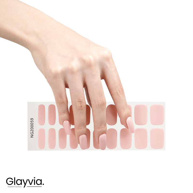 Hand wearing Glayvia NG200059 soft blush pink gloss semi cured gel nail wraps displayed above matching light pink nail wrap sticker sheet