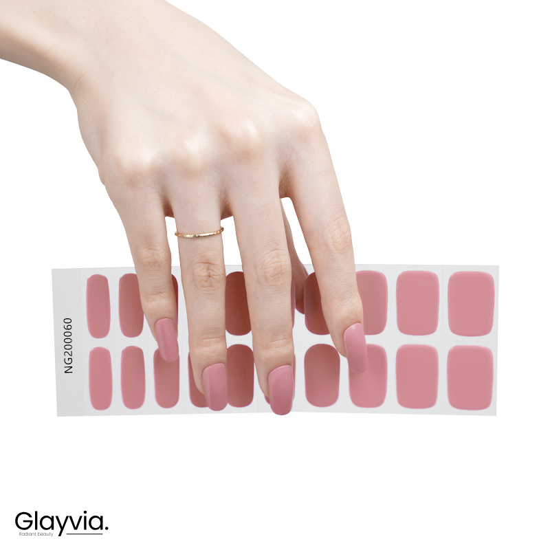 Hand wearing Glayvia NG200060 dusty rose gloss semi cured gel nail wraps displayed above matching muted pink nail wrap sticker sheet