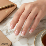 Lifestyle desk shot of Glayvia NG200289 sheer milky semi cured gel nail wraps showing minimal natural manicure