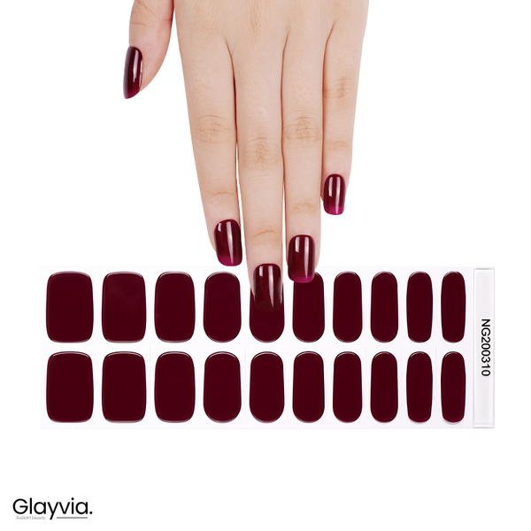 Hand wearing Glayvia NG200310 deep wine red gloss semi cured gel nail wraps displayed above matching rich burgundy nail wrap sticker sheet