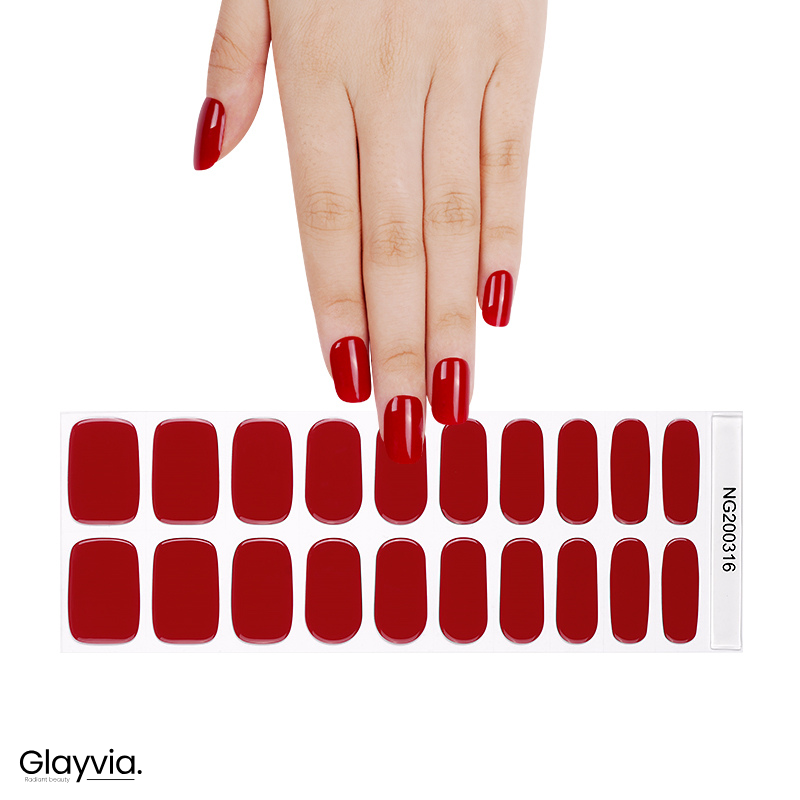 Hand wearing Glayvia NG200316 bright red gloss semi cured gel nail wraps displayed above matching vibrant red nail wrap sticker sheet