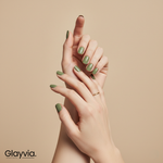 Editorial lifestyle image of two hands wearing Glayvia olive green semi-cured gel nail wraps manicure (NG200028)