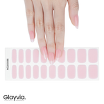 Hand wearing Glayvia soft pink semi-cured gel nail wraps displayed with matching nail wrap sheet (NG200086)