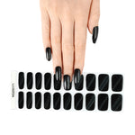 Onyx Cat Eye black semi cured gel nail strips with magnetic shimmer finish displayed on short natural nails with full strip sheet.